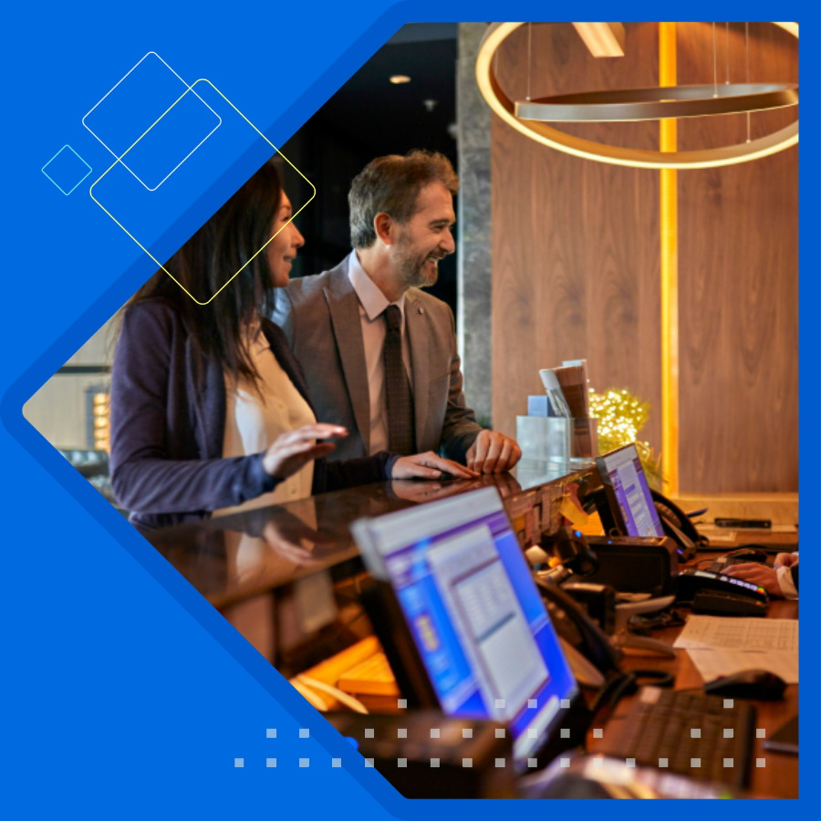 Two men and one women sitting facing latop.