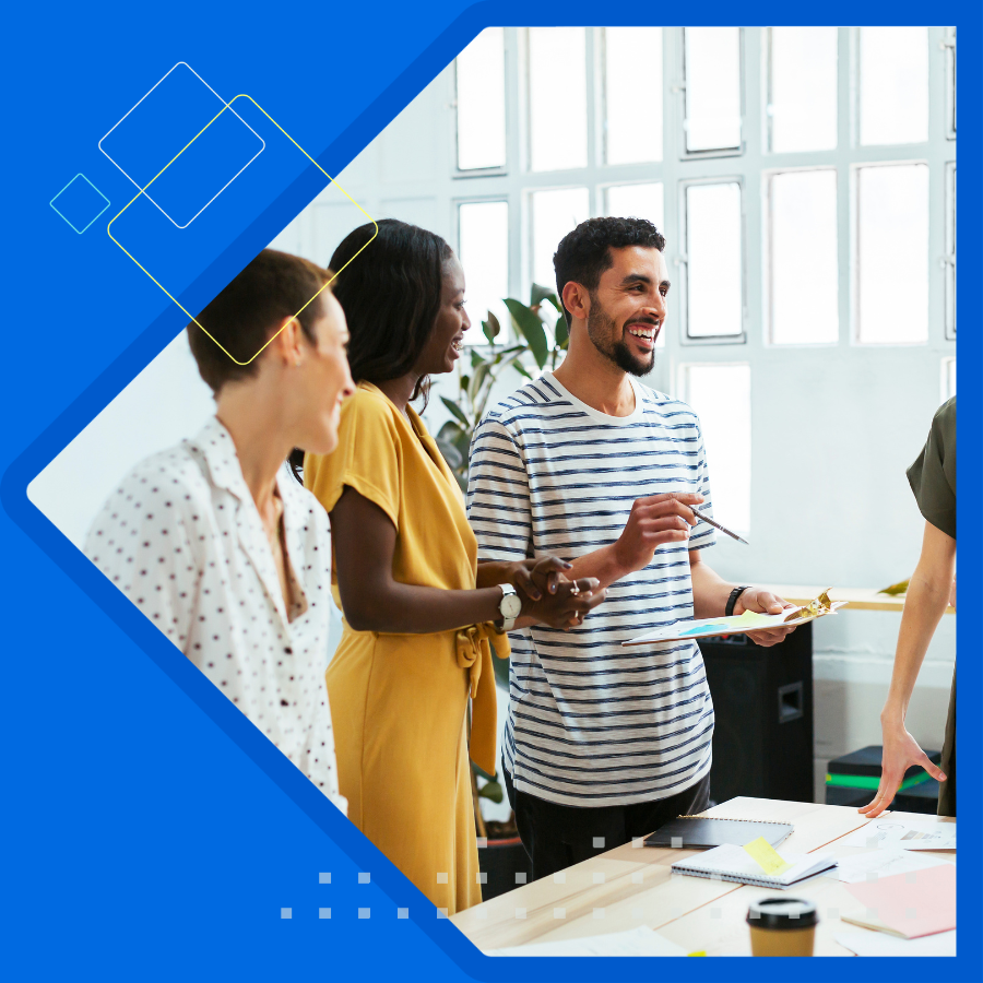 Two men and one women sitting facing latop.